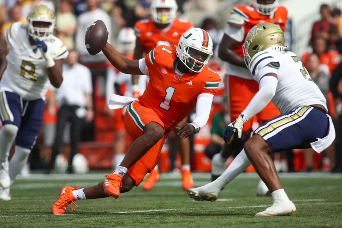Nov 9, 2024; Atlanta, Georgia, USA; Miami Hurricanes quarterback Cam Ward (1) scrambles against the Georgia Tech Yellow Jackets in the second quarter at Bobby Dodd Stadium at Hyundai Field. Mandatory Credit: Brett Davis-Imagn Images