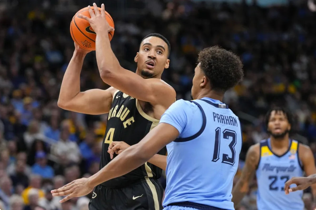 Nov 19, 2024; Milwaukee, Wisconsin, USA; Purdue Boilermakers forward Trey Kaufman-Renn (4) looks to pass the ball as Marquette Golden Eagles forward Royce Parham (13) defends during the first half at Fiserv Forum. Mandatory Credit: Jeff Hanisch-Imagn Images