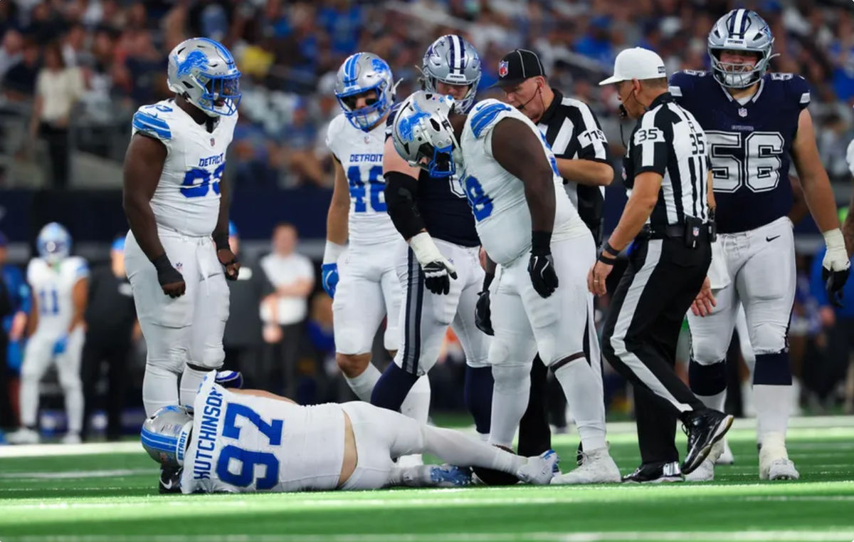 Oct 13, 2024; Arlington, Texas, USA; Detroit Lions defensive end Aidan Hutchinson (97) is injured while trying to tackle Dallas Cowboys quarterback Dak Prescott (not pictured) during the second half at AT&T Stadium. Mandatory Credit: Kevin Jairaj-Imagn Images