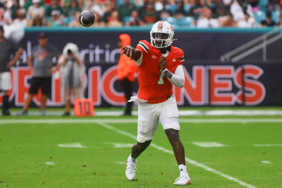 Sep 14, 2024; Miami Gardens, Florida, USA; Miami Hurricanes quarterback Cam Ward (1) passes the football against the Ball State Cardinals during the first quarter at Hard Rock Stadium. Mandatory Credit: Sam Navarro-Imagn Images