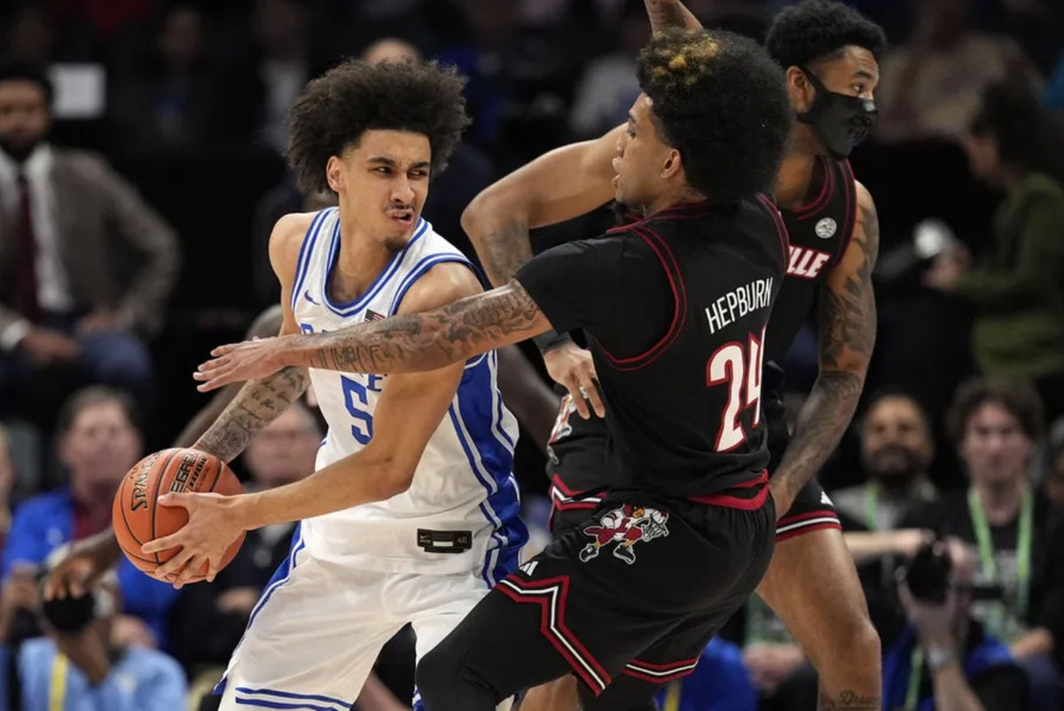 Mar 15, 2025; Charlotte, NC, USA; Duke Blue Devils guard Tyrese Proctor (5) looks to pass against Louisville Cardinals guard Chucky Hepburn (24) in the first half of the 2025 ACC Conference Championship game at Spectrum Center. Mandatory Credit: Jim Dedmon-Imagn Images