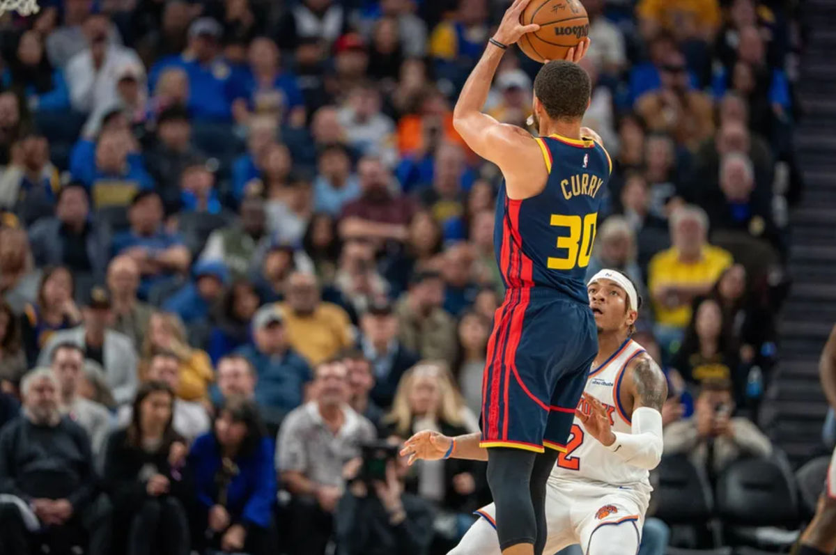 Mar 15, 2025; San Francisco, California, USA; Golden State Warriors guard Stephen Curry (30) makes a three point basket against New York Knicks guard Miles McBride (2) during the second quarter at Chase Center. Mandatory Credit: Neville E. Guard-Imagn Images