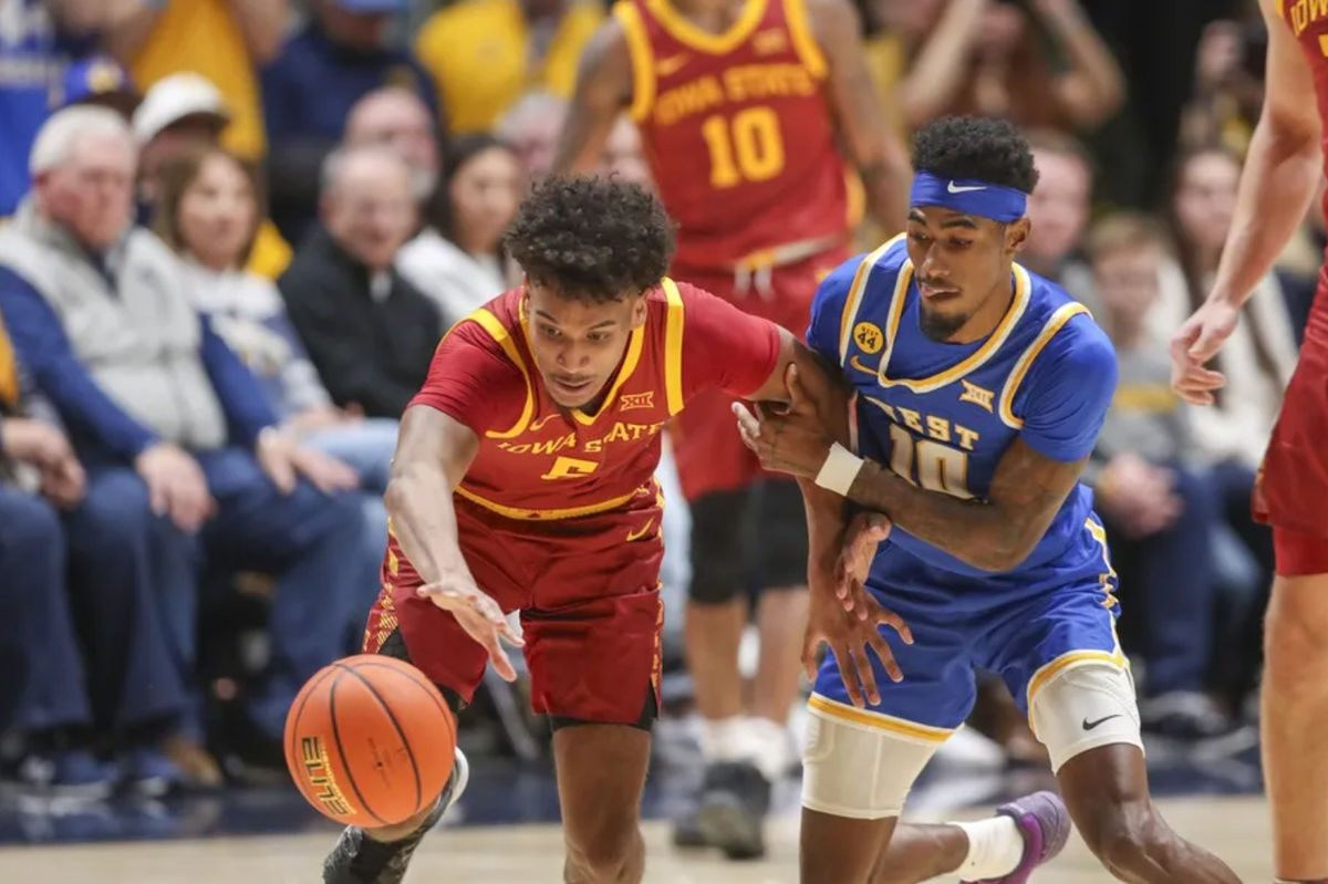 Jan 18, 2025; Morgantown, West Virginia, USA; Iowa State Cyclones guard Curtis Jones (5) and West Virginia Mountaineers guard Sencire Harris (10) fight for a loose ball during the first half at WVU Coliseum. Mandatory Credit: Ben Queen-Imagn Images