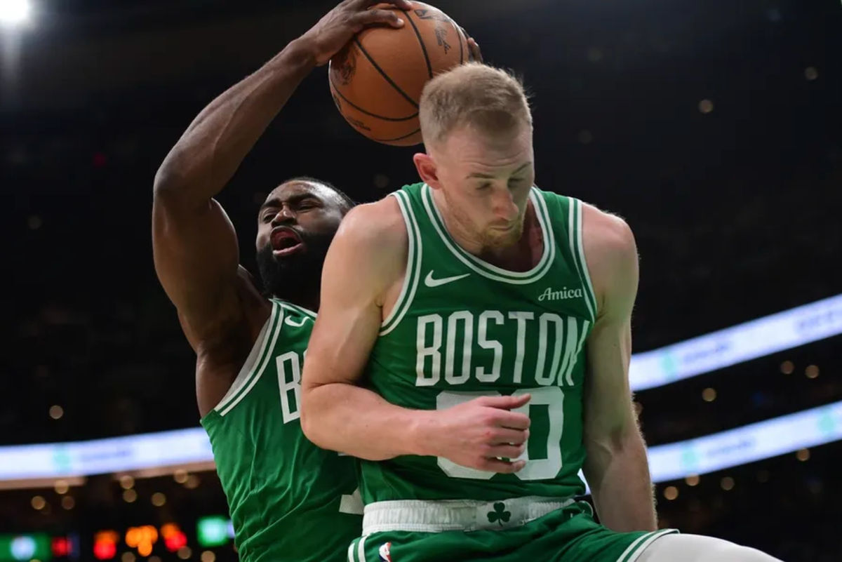Mar 10, 2025; Boston, Massachusetts, USA; Boston Celtics guard Jaylen Brown (7) grabs a rebound in front of forward Sam Hauser (30) during the second half at TD Garden. Mandatory Credit: Bob DeChiara-Imagn Images