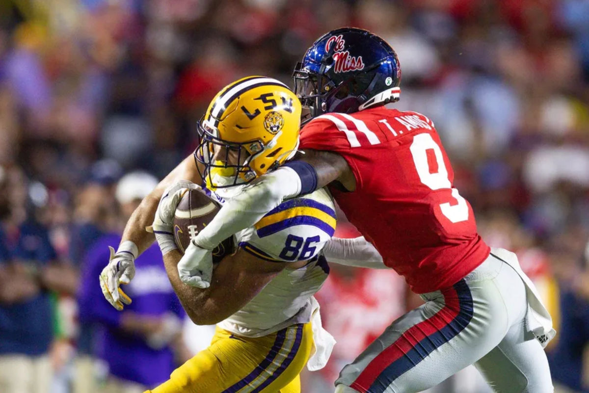 Oct 12, 2024; Baton Rouge, Louisiana, USA; LSU Tigers tight end Mason Taylor (86) makes a first down against Mississippi Rebels cornerback Trey Amos (9) during the second half at Tiger Stadium. Mandatory Credit: Stephen Lew-Imagn Images