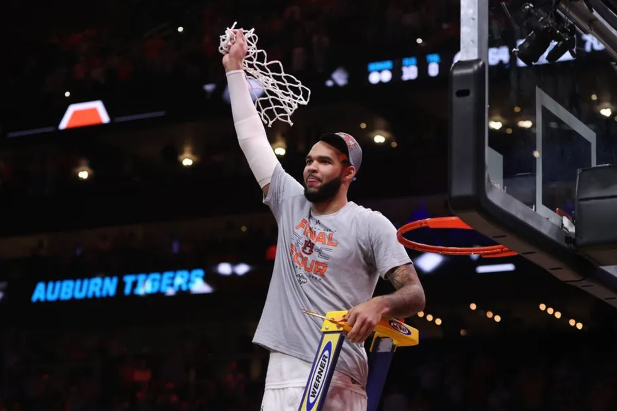 Mar 30, 2025; Atlanta, GA, USA; Auburn Tigers forward Johni Broome (4) cuts down the net after winning the South Regional final of the 2025 NCAA tournament against the Michigan State Spartans at State Farm Arena. Mandatory Credit: Brett Davis-Imagn Images