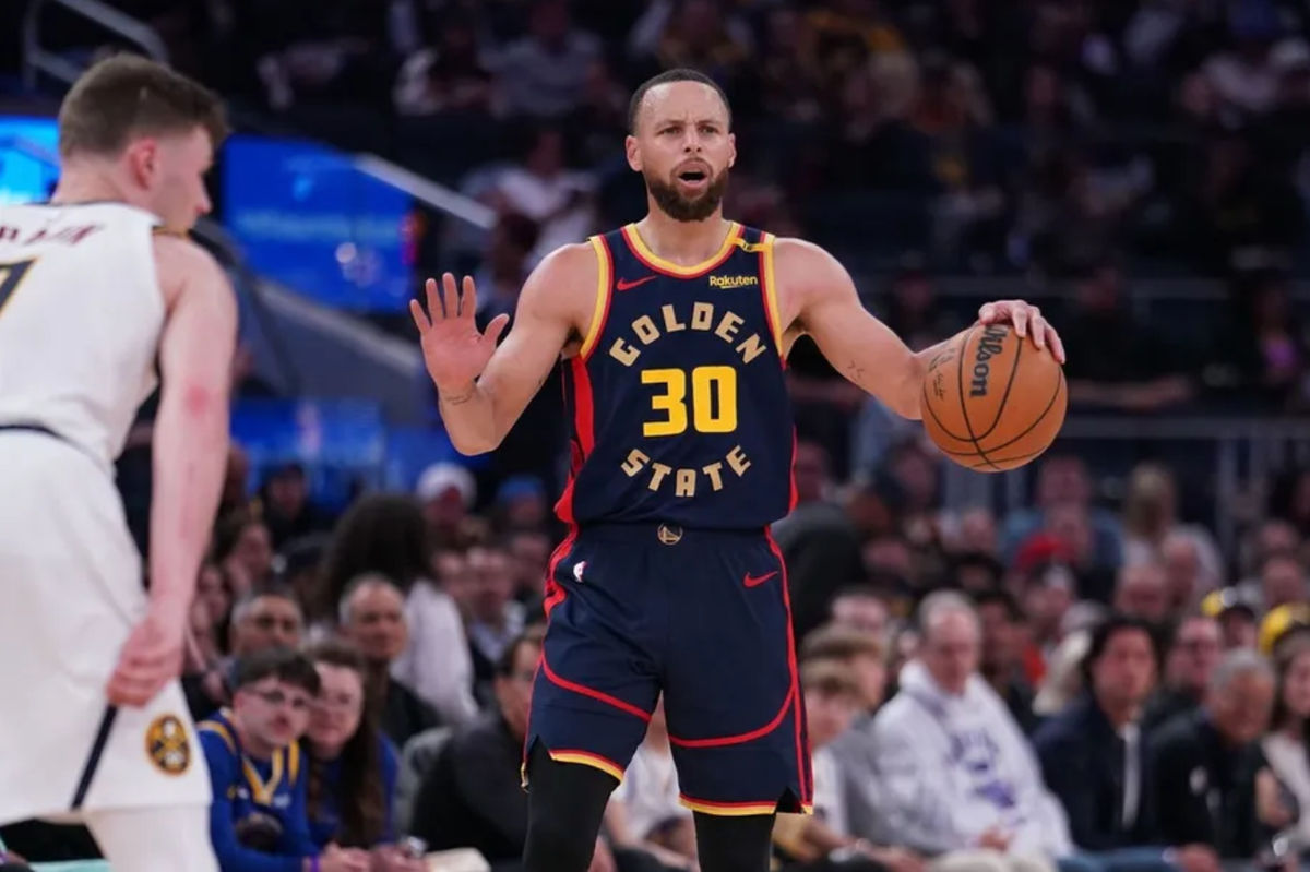 Apr 4, 2025; San Francisco, California, USA; Golden State Warriors guard Stephen Curry (30) slows the tempo in the third period while defended by Denver Nuggets guard Christian Braun (0) at Chase Center. Mandatory Credit: David Gonzales-Imagn Images