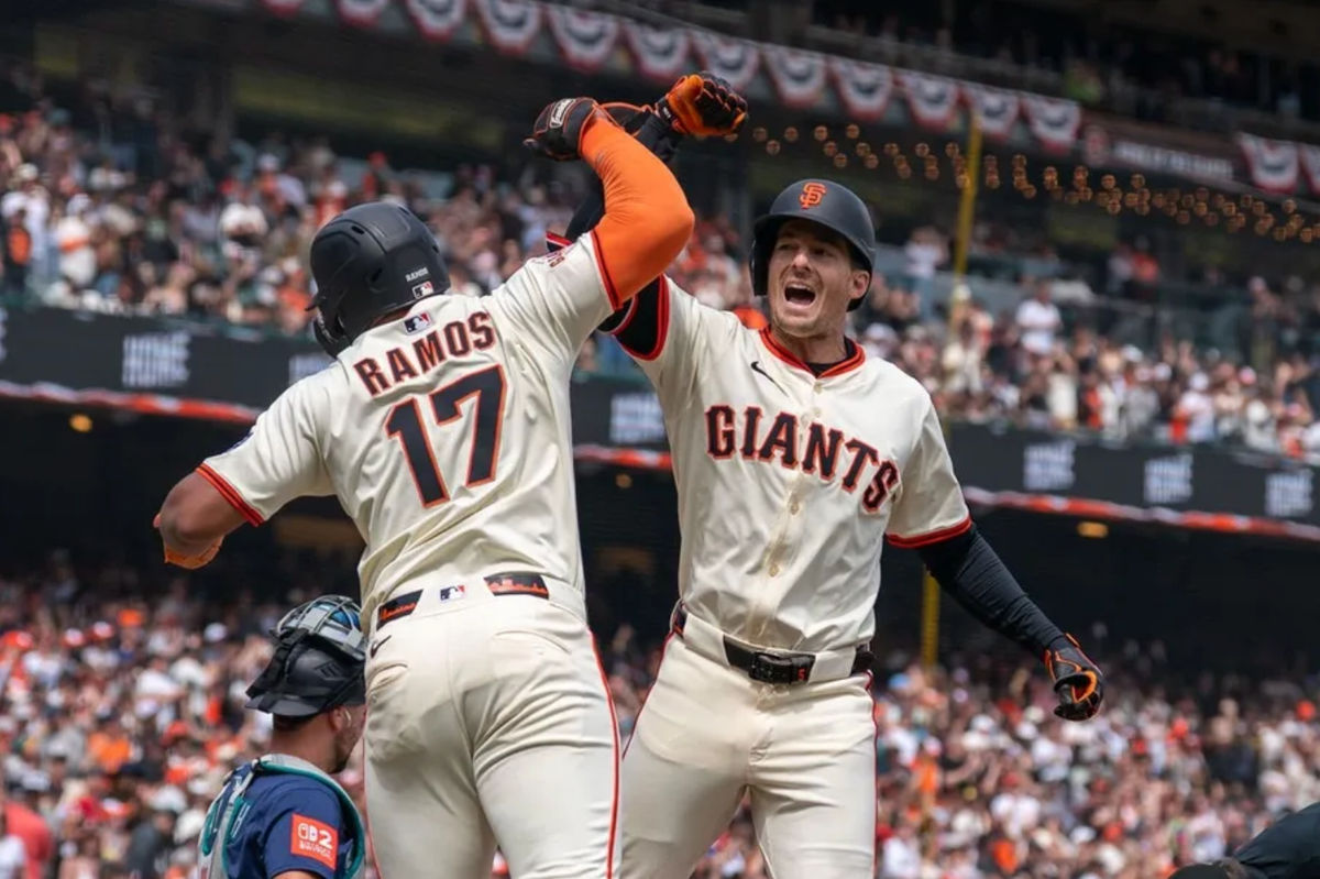 Apr 6, 2025; San Francisco, California, USA; San Francisco Giants designated hitter Heliot Ramos (17) gives for arm bashes toSan Francisco Giants right fielder Mike Yastrzemski (5) for the three run home against the Seattle Mariners during the fourth inning at Oracle Park. Mandatory Credit: Neville E. Guard-Imagn Images
