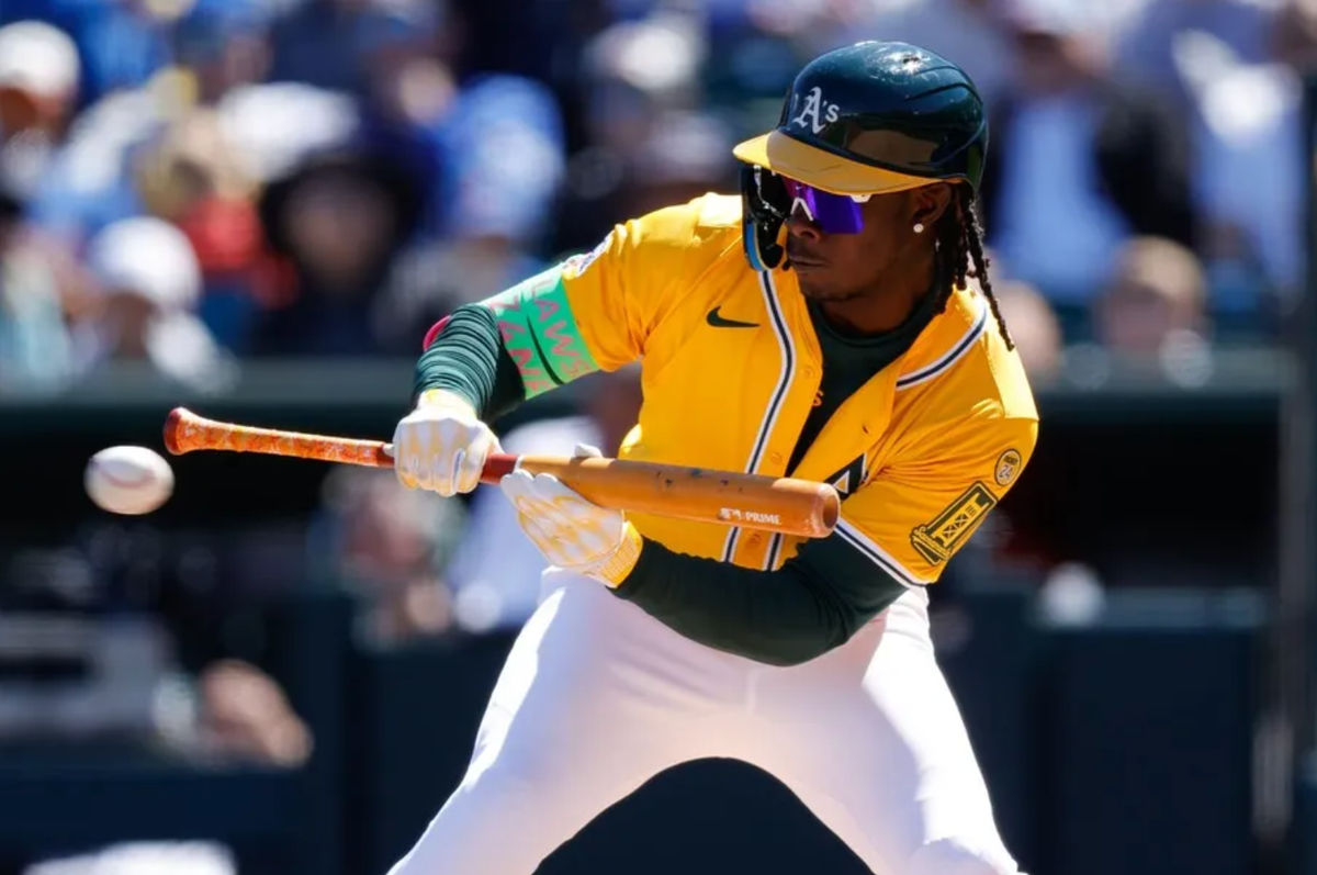 Apr 2, 2025; West Sacramento, California, USA; Athletics outfielder Lawrence Butler (4) lays down a bunt during the third inning against the Chicago Cubs at Sutter Health Park. Mandatory Credit: Sergio Estrada-Imagn Images