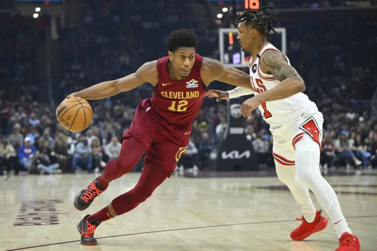 Apr 8, 2025; Cleveland, Ohio, USA; Cleveland Cavaliers forward De'Andre Hunter (12) dribbles past Chicago Bulls guard Jahmir Young (17) in the first quarter at Rocket Arena. Mandatory Credit: David Richard-Imagn Images