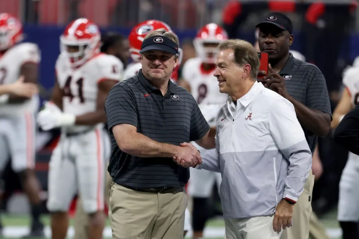 Dec 4, 2021; Atlanta, GA, USA; Georgia Bulldogs head coach Kirby Smart greets Alabama Crimson Tide head coach Nick Saban before the SEC championship game at Mercedes-Benz Stadium. Mandatory Credit: Jason Getz-Imagn Images