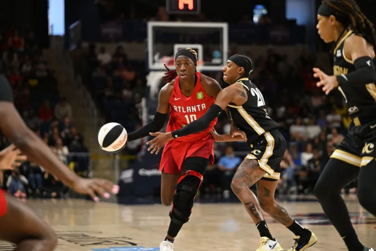 Jun 15, 2025; Washington, District of Columbia, USA; Atlanta Dream guard Rhyne Howard (10) attempts to drive past Washington Mystics guard Brittney Sykes (20) during the second quarter at CareFirst Arena. Mandatory Credit: Rafael Suanes-Imagn Images