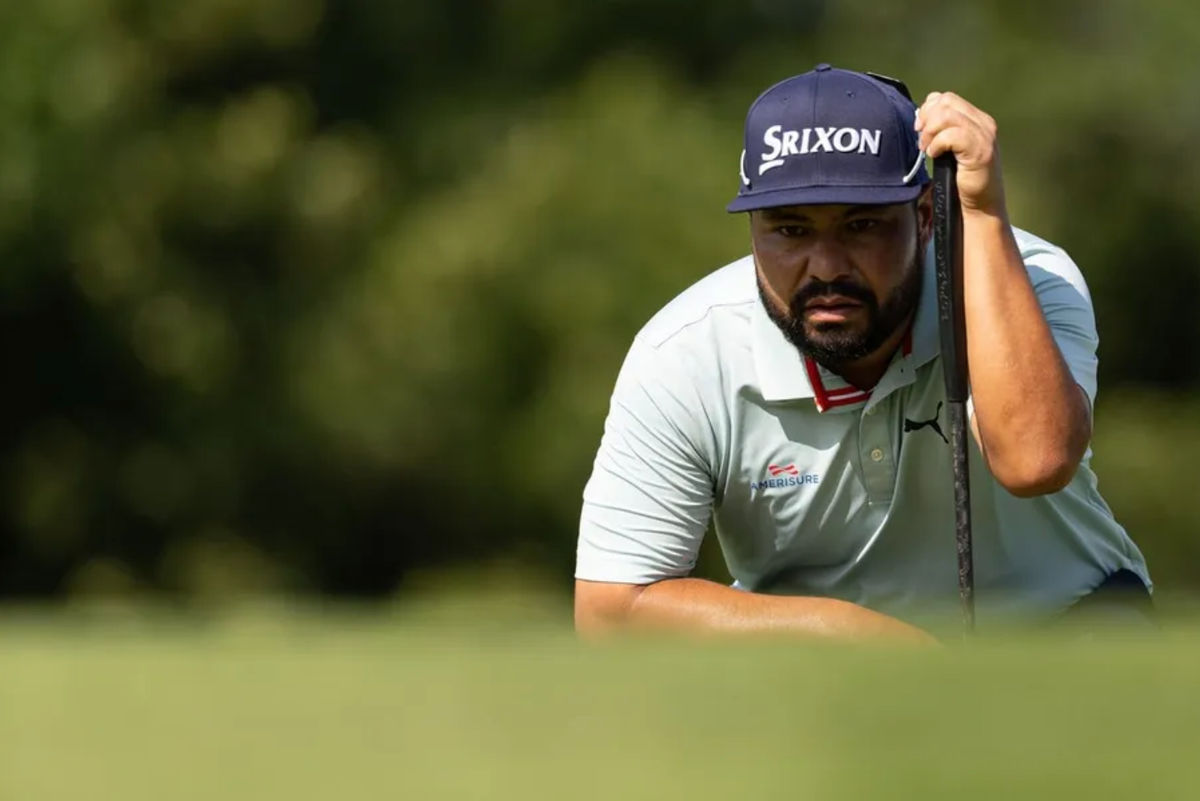 Jun 19, 2025; Cromwell, Connecticut, USA; J.J. Spaun lines up a putt on the 12th hole during the first round of the Travelers Championship golf tournament. Mandatory Credit: Bill Streicher-Imagn Images