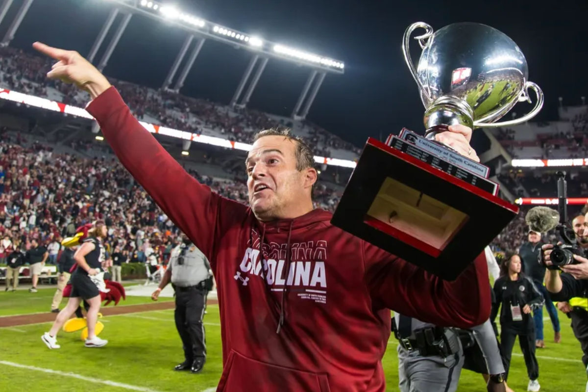 Nov 16, 2024; Columbia, South Carolina, USA; South Carolina Gamecocks head coach Shane Beamer celebrates beating the Missouri Tigers at Williams-Brice Stadium. He is holding the Mayors Cup, given to the winner of the South Carolina-Missouri game. Mandatory Credit: Jeff Blake-Imagn Images