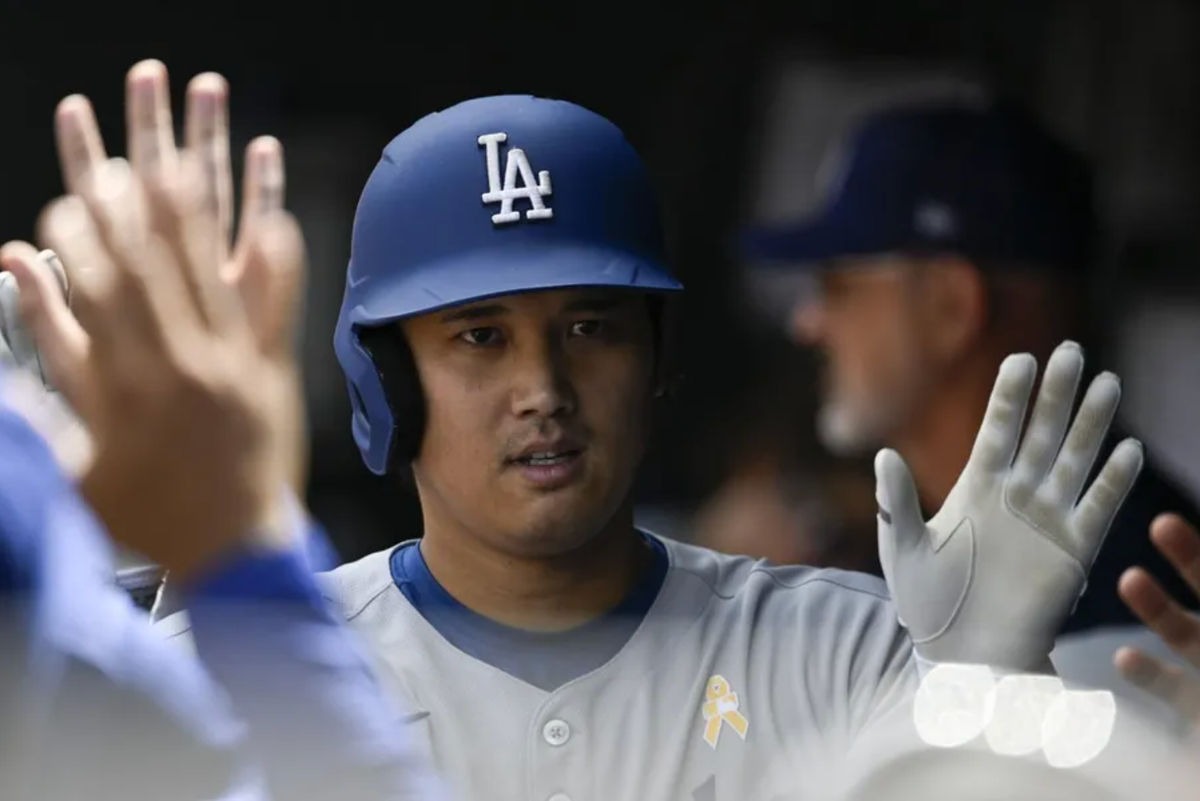 Sep 7, 2025; Baltimore, Maryland, USA; Los Angeles Dodgers designated hitter Shohei Ohtani (17) celebrates with teammates in the dugout after hitting a third inning solo home run against the Baltimore Orioles at Oriole Park at Camden Yards. Mandatory Credit: Tommy Gilligan-Imagn Images