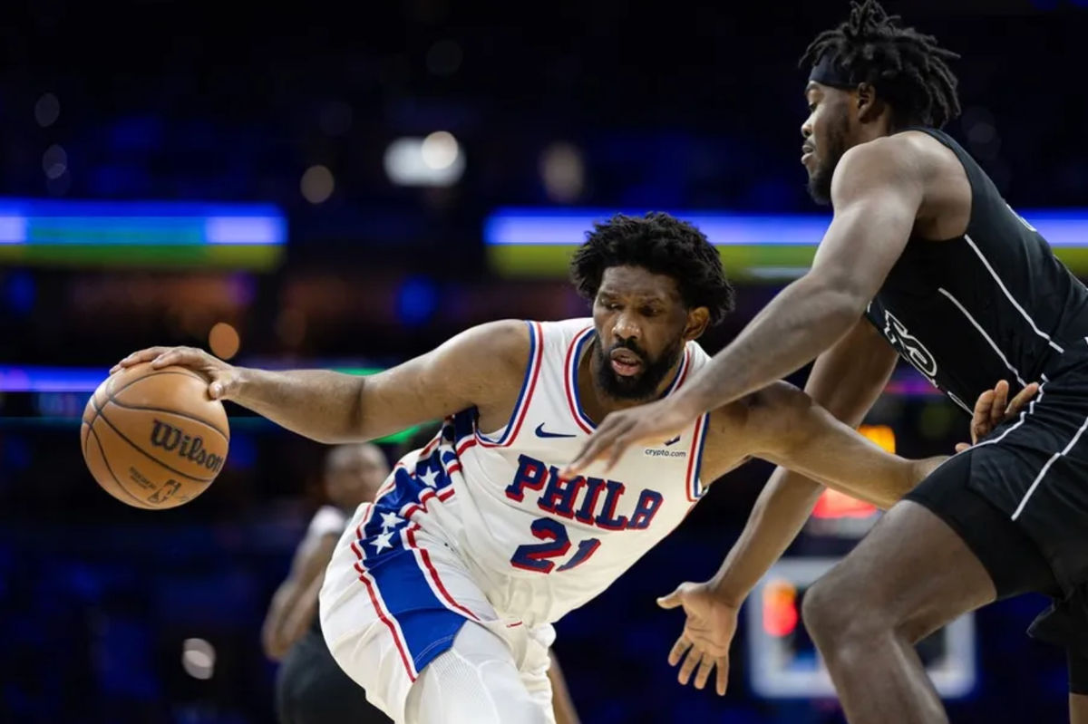 Feb 22, 2025; Philadelphia, Pennsylvania, USA; Philadelphia 76ers center Joel Embiid (21) controls the ball against Brooklyn Nets center Day'Ron Sharpe (20) during the third quarter at Wells Fargo Center. Mandatory Credit: Bill Streicher-Imagn Images