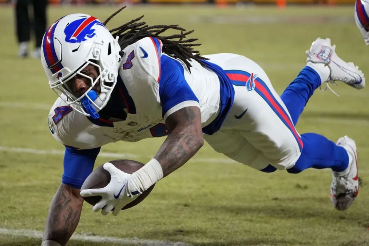 Jan 26, 2025; Kansas City, MO, USA; Buffalo Bills running back James Cook (4) dives for a touchdown against the Kansas City Chiefs in the AFC Championship game at GEHA Field at Arrowhead Stadium. Mandatory Credit: Denny Medley-Imagn Images