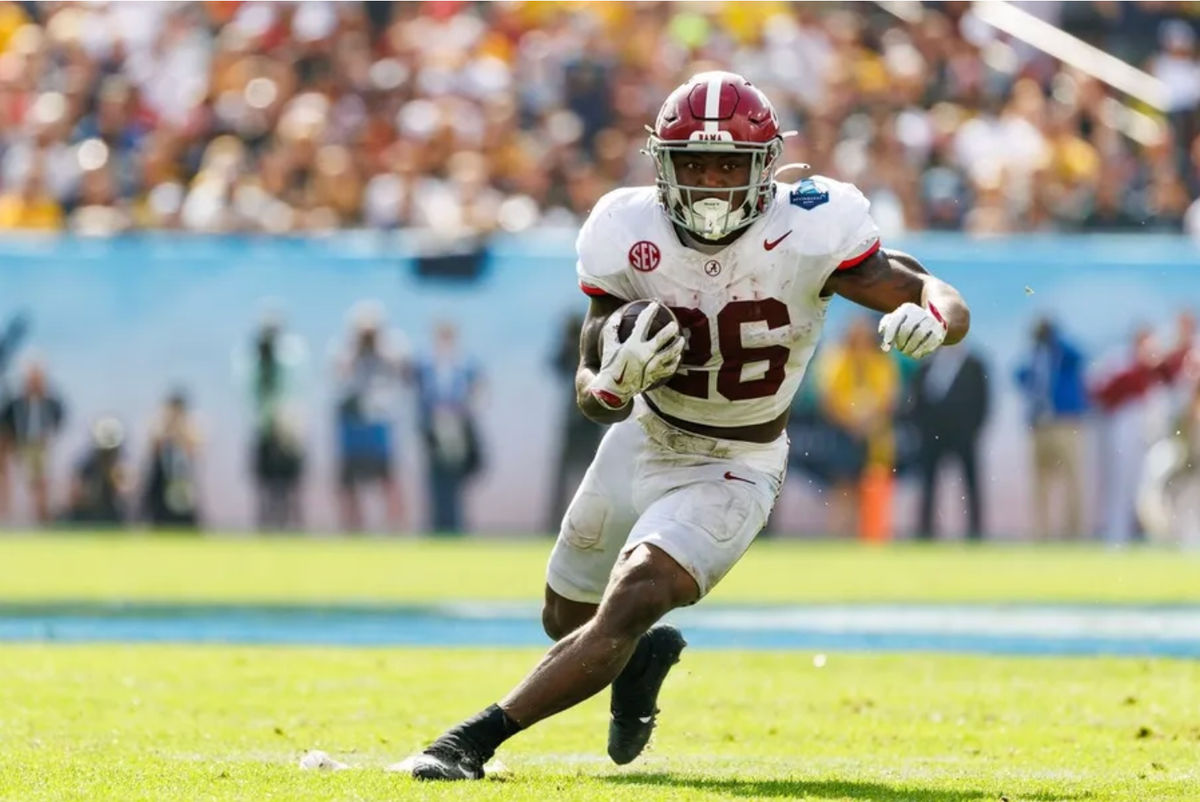 Dec 31, 2024; Tampa, FL, USA; Alabama Crimson Tide running back Jam Miller (26) rushes with the ball against the Michigan Wolverines during the first half at Raymond James Stadium. Mandatory Credit: Matt Pendleton-Imagn Images