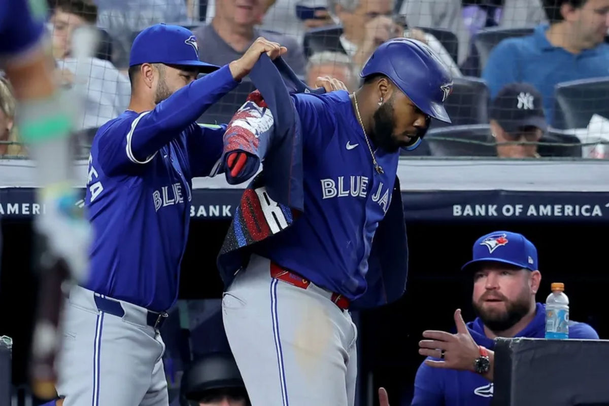 Sep 5, 2025; Bronx, New York, USA; Toronto Blue Jays shortstop Isiah Kiner-Falefa (7) puts the home run jacket on first baseman Vladimir Guerrero Jr. (27) after Guerrero hit a solo home run the New York Yankees during the fifth inning at Yankee Stadium. Mandatory Credit: Brad Penner-Imagn Images