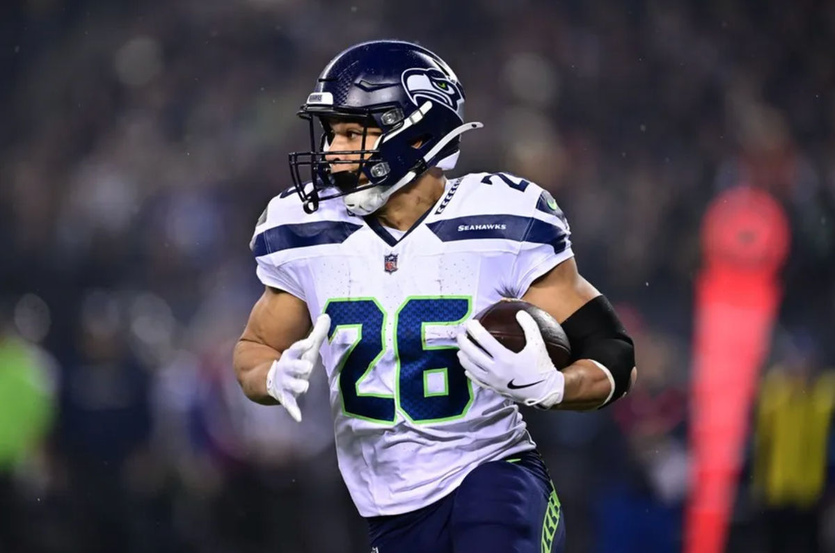Dec 26, 2024; Chicago, Illinois, USA; Seattle Seahawks running back Zach Charbonnet (26) runs the ball against the Chicago Bears during the first quarter at Soldier Field. Mandatory Credit: Daniel Bartel-Imagn Images