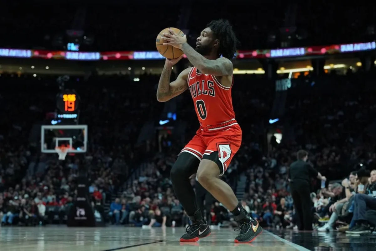 Nov 19, 2025; Portland, Oregon, USA; Chicago Bulls guard Coby White (0) shoots a three-point basket during the first half against the Portland Trail Blazers at Moda Center. Mandatory Credit: Soobum Im-Imagn Images