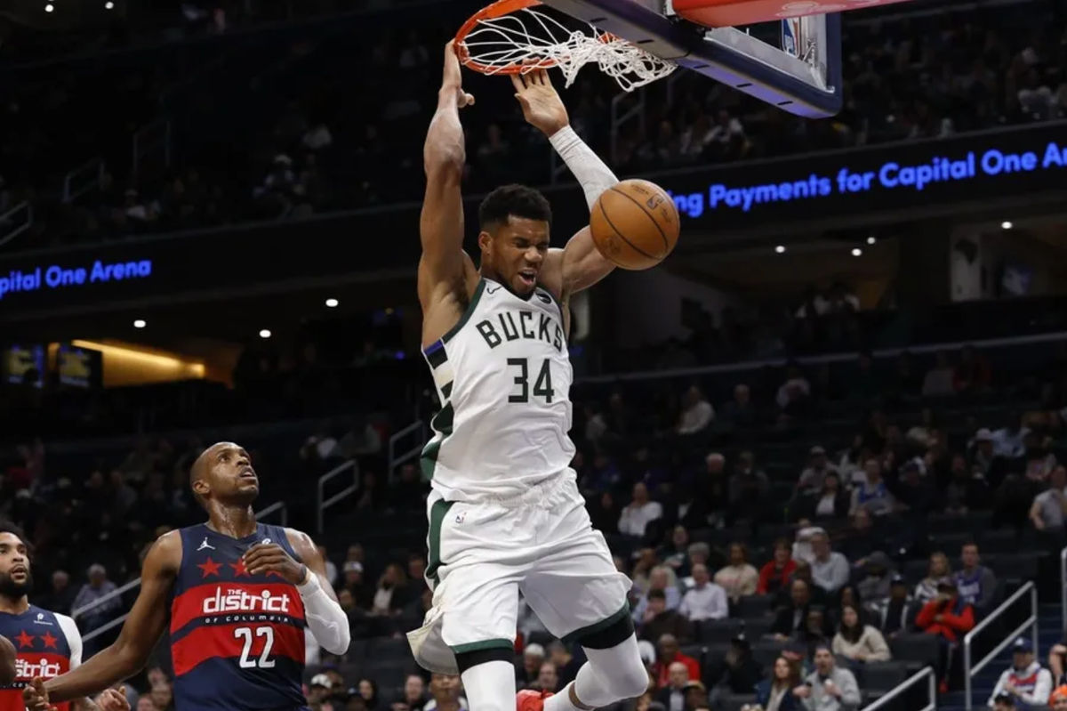 Dec 1, 2025; Washington, District of Columbia, USA; Milwaukee Bucks forward Giannis Antetokounmpo (34) dunks the ball as Washington Wizards forward Khris Middleton (22) looks on in the second quarter at Capital One Arena. Mandatory Credit: Geoff Burke-Imagn Images