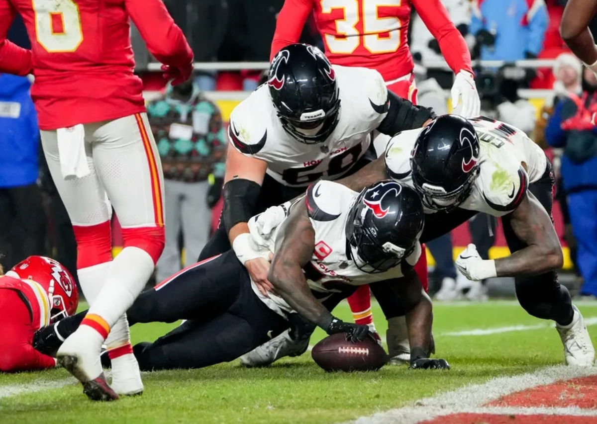 Dec 7, 2025; Kansas City, Missouri, USA; Houston Texans running back Dare Ogunbowale (33) scores a touchdown during the fourth quarter against the Kansas City Chiefs at GEHA Field at Arrowhead Stadium. Mandatory Credit: Denny Medley-Imagn Images