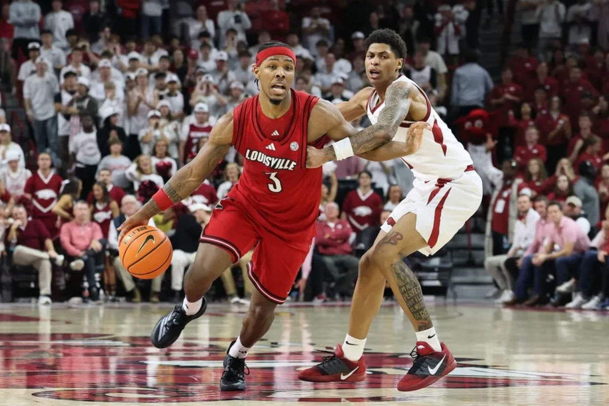 Dec 3, 2025; Fayetteville, Arkansas, USA; Louisville Cardinals guard Ryan Conwell (3) dribbles around Arkansas Razorbacks guard Meleek Thomas (1) during the second half at Bud Walton Arena. Arkansas won 89-80. Mandatory Credit: Nelson Chenault-Imagn Images