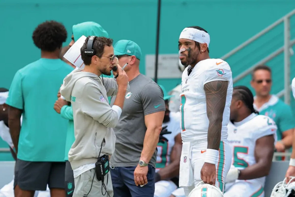 Sep 14, 2025; Miami Gardens, Florida, USA;Miami Dolphins head coach Mike McDaniel and quarterback Tua Tagovailoa (1) stand on the sideline against the New England Patriots during the second quarter at Hard Rock Stadium. Mandatory Credit: Sam Navarro-Imagn Images