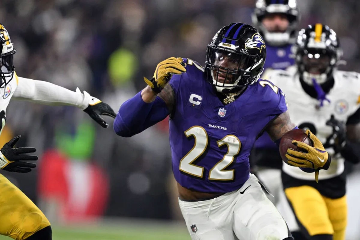 Jan 11, 2025; Baltimore, Maryland, USA; Baltimore Ravens running back Derrick Henry (22) runs against Pittsburgh Steelers linebacker Elandon Roberts (50) in the second quarter in an AFC wild card game at M&amp;T Bank Stadium. Mandatory Credit: Tommy Gilligan-Imagn Images