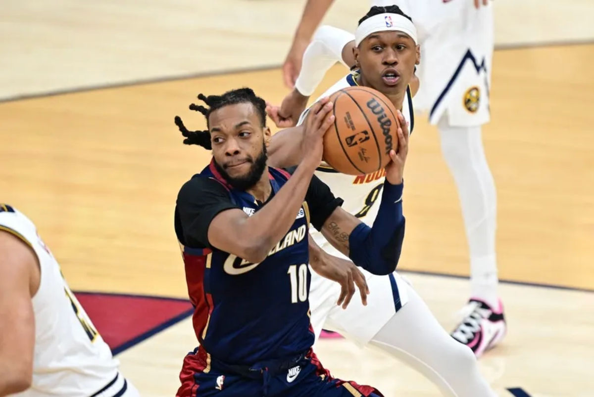 Jan 2, 2026; Cleveland, Ohio, USA; Cleveland Cavaliers guard Darius Garland (10) looks to pass while being defended by Denver Nuggets guard Peyton Watson (8) during the first half at Rocket Arena. Mandatory Credit: David Dermer-Imagn Images