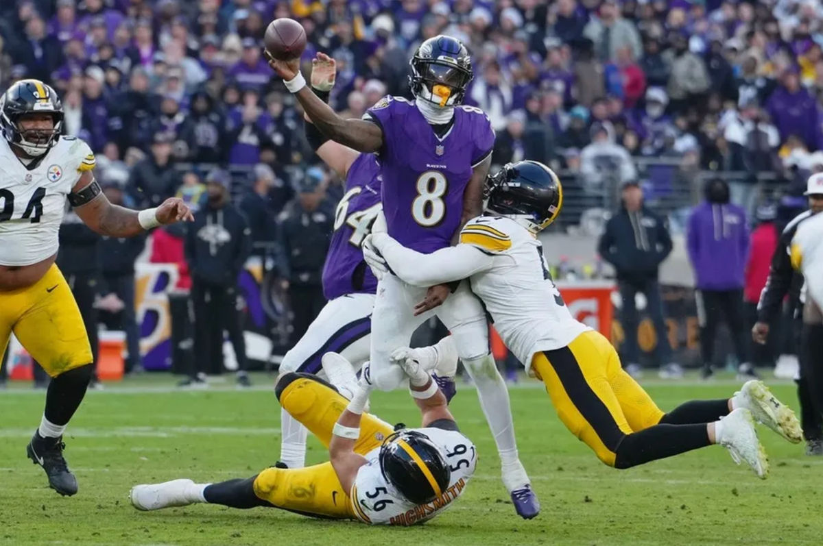 Dec 7, 2025; Baltimore, Maryland, USA; Baltimore Ravens quarterback Lamar Jackson (8) passes the ball while defended by Pittsburgh Steelers linebacker Alex Highsmith (56) and linebacker Nick Herbig (51) during the second half at M&amp;T Bank Stadium. Mandatory Credit: Mitch Stringer-Imagn Images