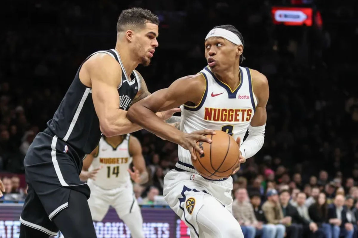Jan 4, 2026; Brooklyn, New York, USA; Denver Nuggets guard Peyton Watson (8) looks to drive past Brooklyn Nets forward Michael Porter Jr. (17) in the first quarter at Barclays Center. Mandatory Credit: Wendell Cruz-Imagn Images