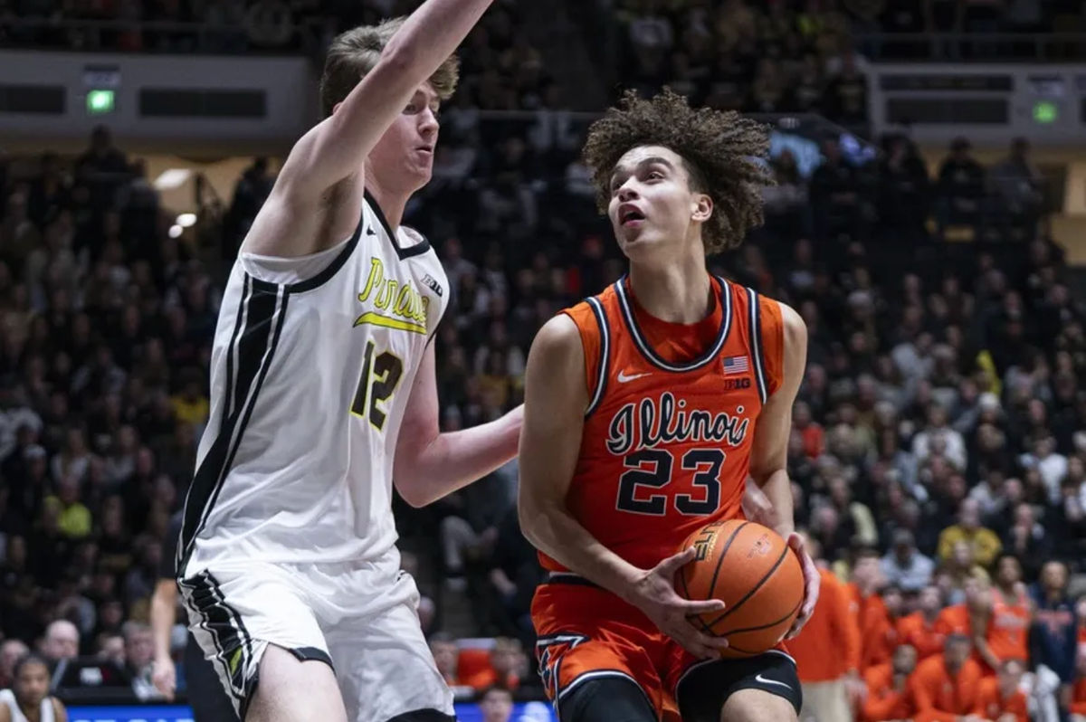 Jan 24, 2026; West Lafayette, Indiana, USA; Illinois Fighting Illini guard Keaton Wagler (23) dribbles past Purdue Boilermakers center Daniel Jacobsen (12) during the first half at Mackey Arena. Mandatory Credit: Jacob Musselman-Imagn Images