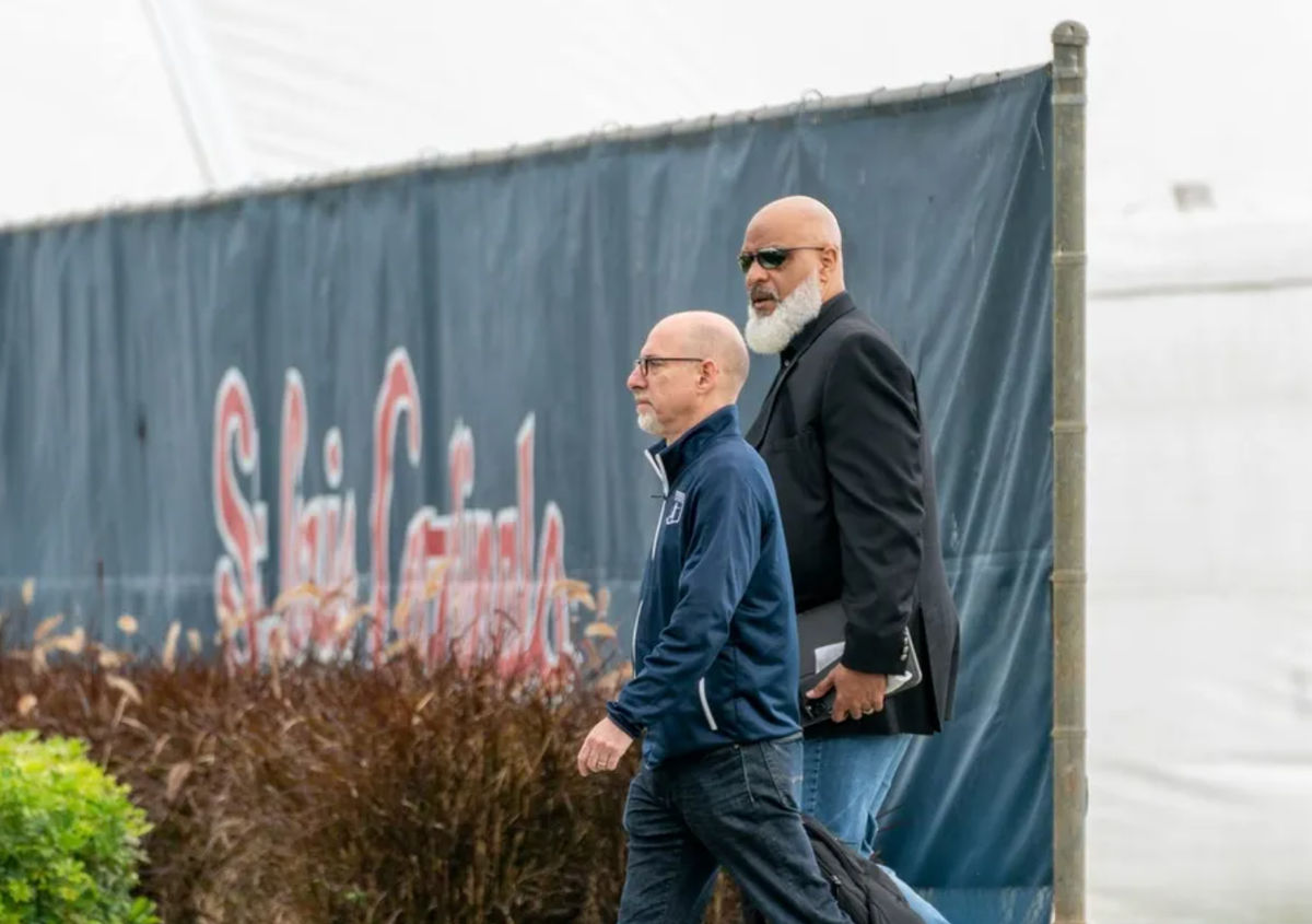 Major League Baseball Players Association executive director Tony Clark, right, and chief negotiator Bruce Meyer arrive for negotiations with the players union in an attempt to reach an agreement to salvage March 31 openers and a 162-game season, March 1, 2022, at Roger Dean Stadium in Jupiter, Florida.