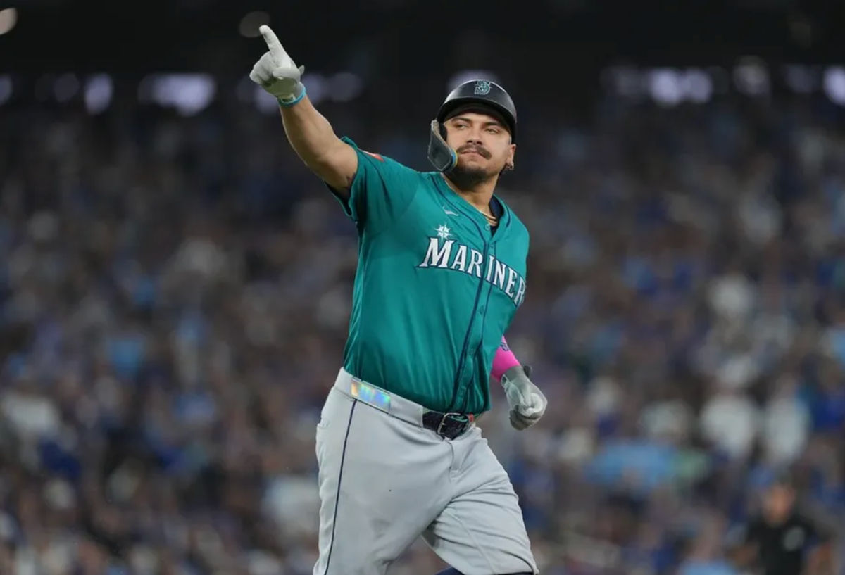 Oct 19, 2025; Toronto, Ontario, CAN; Seattle Mariners first baseman Josh Naylor (12) reacts after hitting a home run in the sixth inning against the Toronto Blue Jays during game six of the ALCS round for the 2025 MLB playoffs at Rogers Centre. Mandatory Credit: Nick Turchiaro-Imagn Images