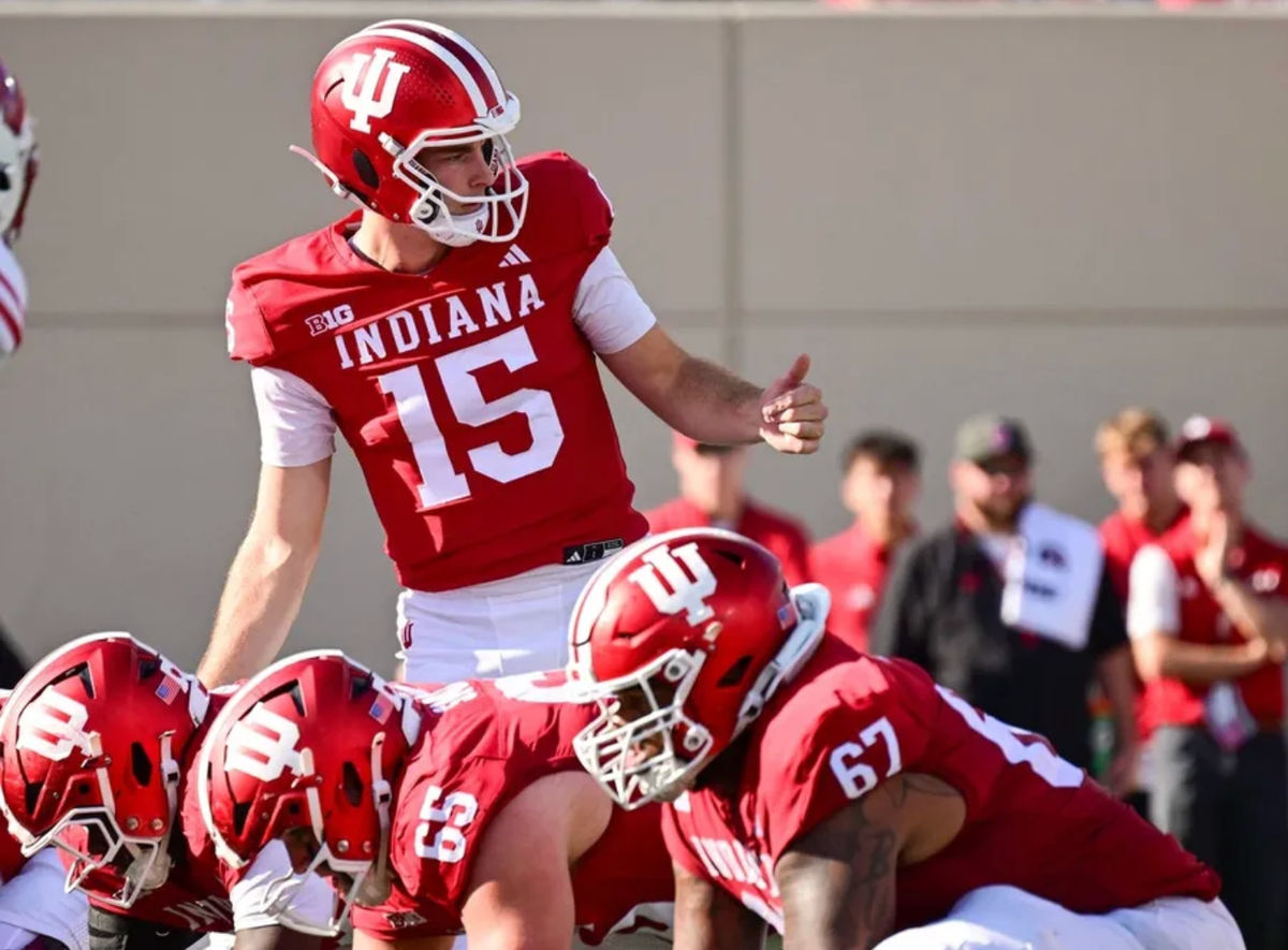 Nov 15, 2025; Bloomington, Indiana, USA; Indiana Hoosiers quarterback Fernando Mendoza (15) motions to his team during the second half against the Wisconsin Badgers at Memorial Stadium. Mandatory Credit: Marc Lebryk-Imagn Images