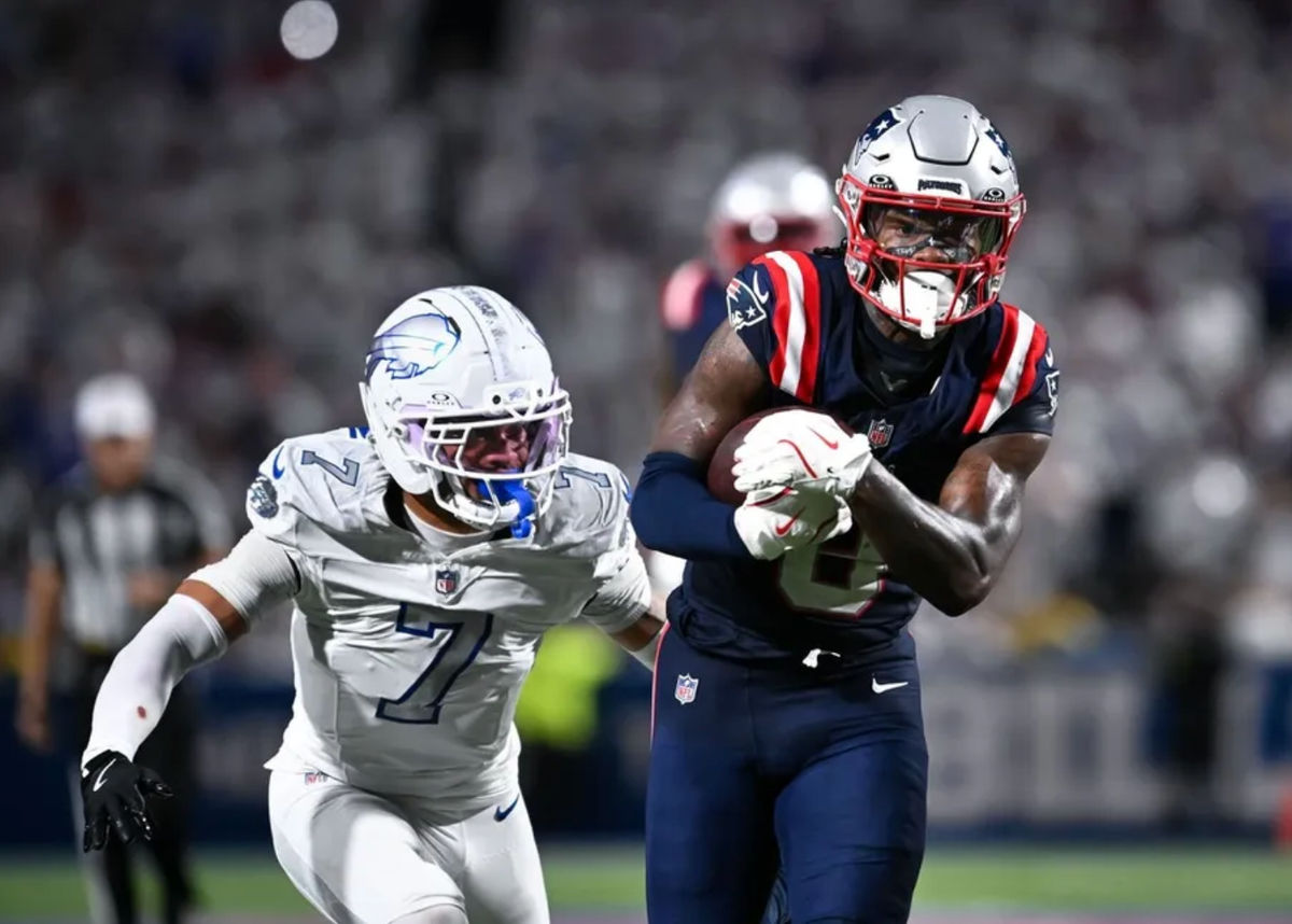 Oct 5, 2025; Orchard Park, New York, USA; New England Patriots wide receiver Stefon Diggs (8) protects the ball from Buffalo Bills cornerback Taron Johnson (7) after making a catch in the fourth quarter at Highmark Stadium. Mandatory Credit: Mark Konezny-Imagn Images