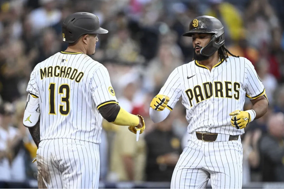 Jul 10, 2025; San Diego, California, USA; San Diego Padres right fielder Fernando Tatis Jr. (23) is congratulated by Manny Machado (13) after hitting a solo home run during the third inning against the Arizona Diamondbacks at Petco Park. Mandatory Credit: Denis Poroy-Imagn Images a