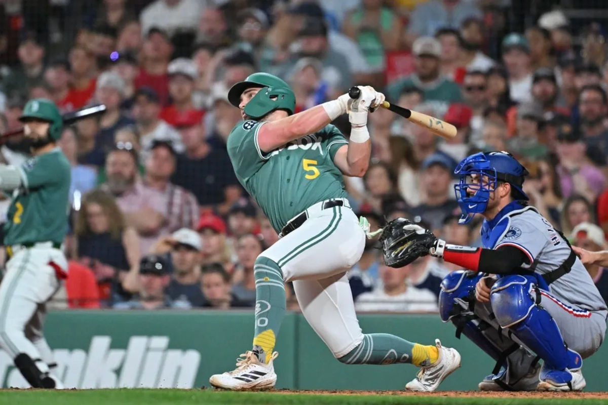 Jun 12, 2026; Boston, Massachusetts, USA; Boston Red Sox third baseman Caleb Durbin (5) hits a sacrifice fly ball to bring first baseman Willson Contreras (40) (not pictured) in for a run against the Texas Rangers during the fifth inning at Fenway Park. Mandatory Credit: Eric Canha-Imagn Images