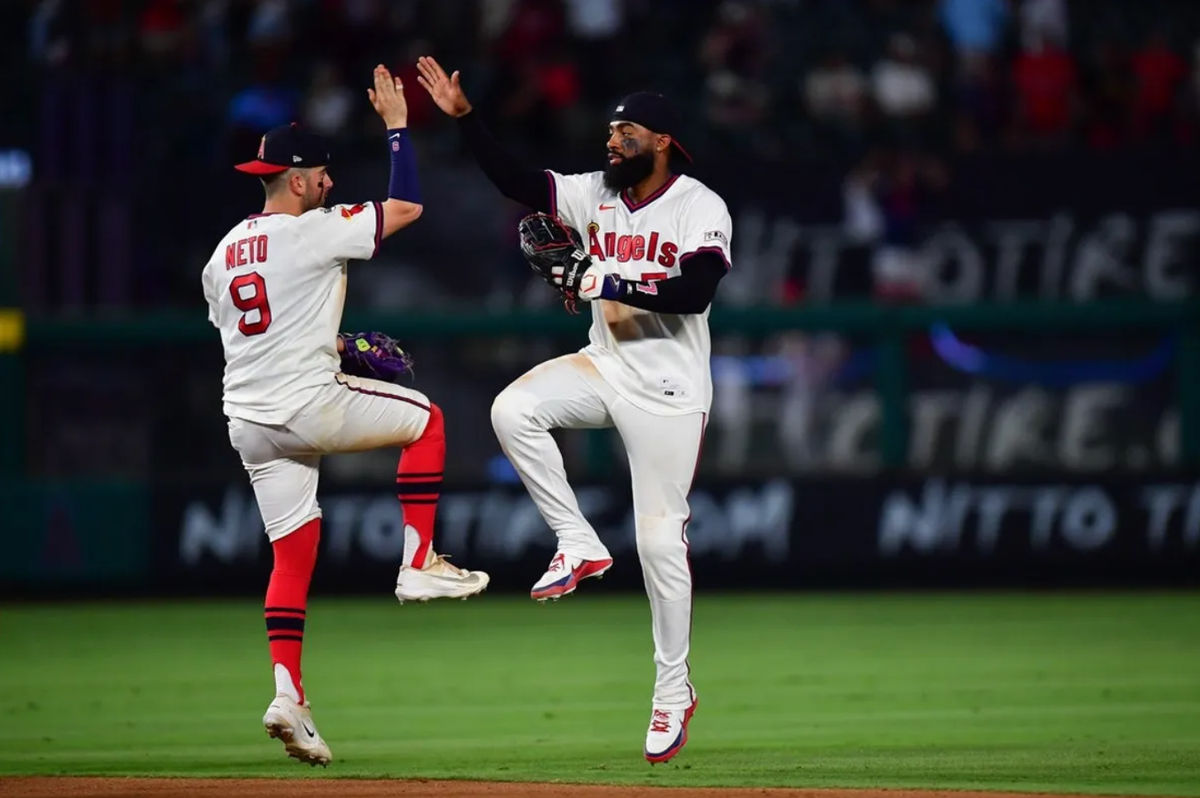 Jul 21, 2026; Anaheim, California, USA; Los Angeles Angels shortstop Zach Neto (9) and right fielder Jo Adell (7) celebrate the victory against the St. Louis Cardinals at Angel Stadium. Mandatory Credit: Gary A. Vasquez-Imagn Images
