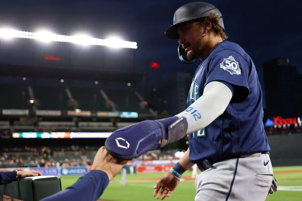Jun 8, 2026; Baltimore, Maryland, USA; Seattle Mariners first baseman Josh Naylor (12) celebrates with his teammates after scoring a run during the eighth inning against the Baltimore Orioles at Oriole Park at Camden Yards. Mandatory Credit: Daniel Kucin Jr.-Imagn Images