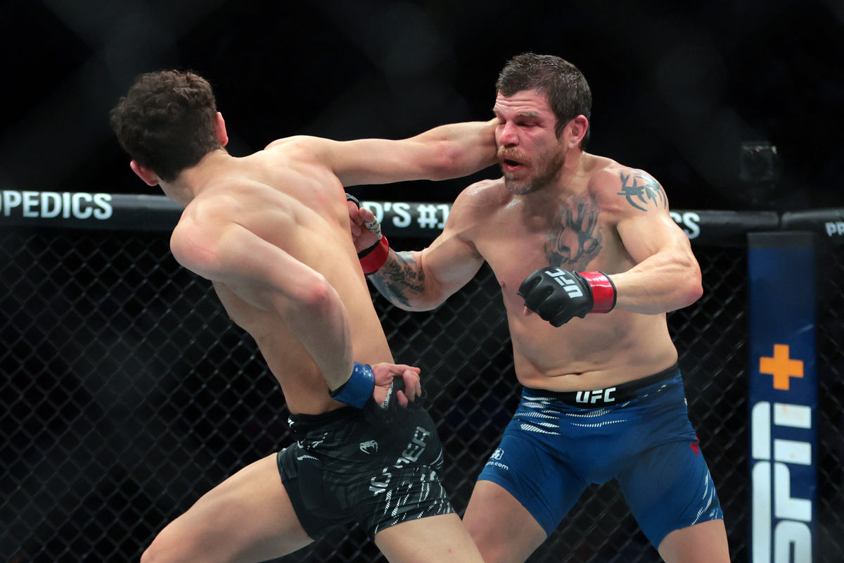Apr 12, 2025; Miami, Florida, UNITED STATES; Jim Miller (red gloves) fights against Chase Hooper (blue gloves) during UFC 314 at Kaseya Center. Mandatory Credit: Sam Navarro-Imagn Images