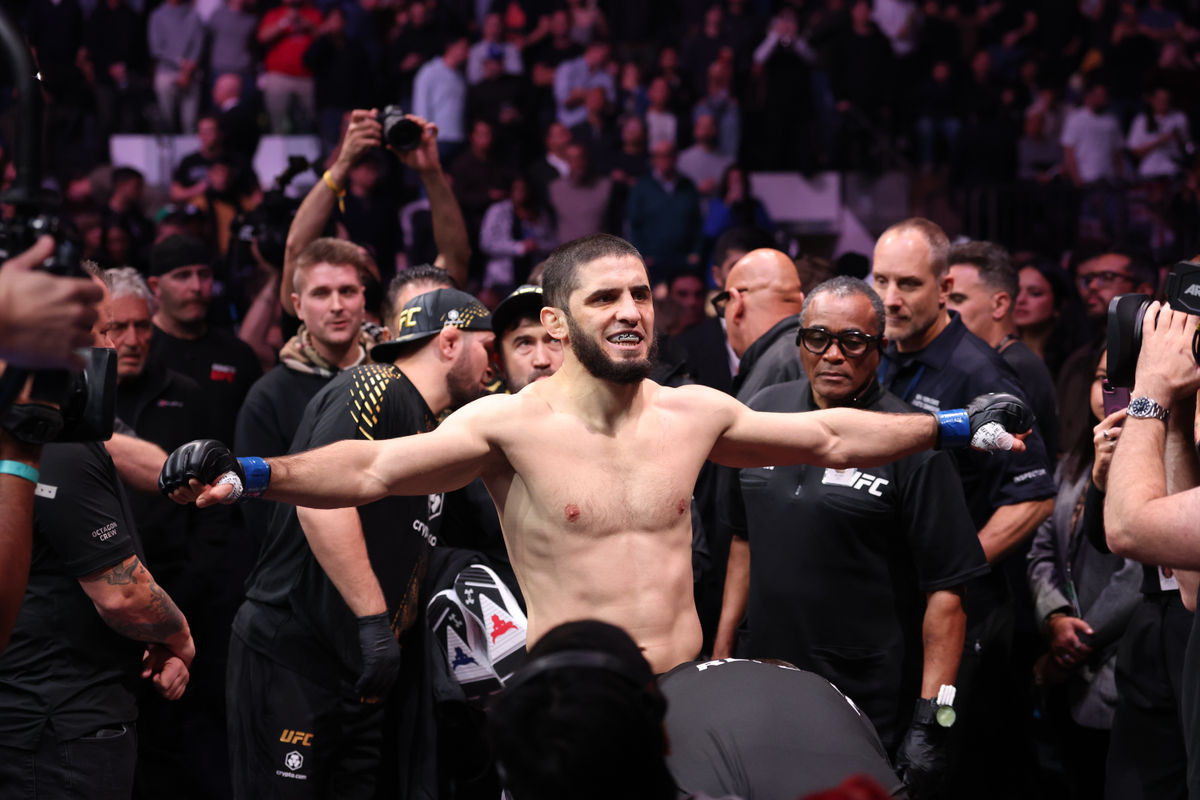 Nov 15, 2025; New York, NY, UNITED STATES; Islam Makhachev (blue gloves) walks in before the welterweight championship bout against Jack Della Maddalena (not pictured) during UFC 322 at Madison Square Garden. Mandatory Credit: Ed Mulholland-Imagn Images