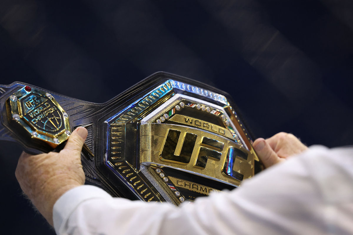 Jun 14, 2026; Washington, D.C., UNITED STATES; An official holds aUFC world championship belt during UFC Freedom 250 at White House South Lawn. Mandatory Credit: Amber Searls-Imagn Images