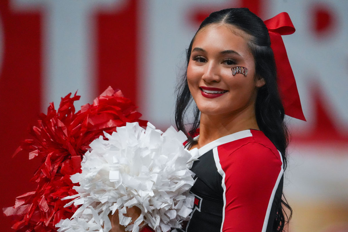 Dec 23, 2025; Frisco, TX, USA; A UNLV Rebels cheerleader shows her spirit during the second half of a game against the Ohio Bobcats at the Ford Center at The Star. Mandatory Credit: Raymond Carlin III-Imagn Images