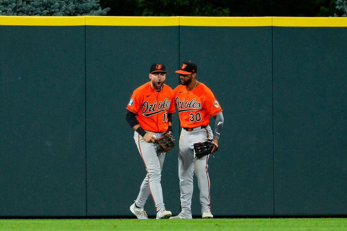 Aug 31, 2026; Denver, Colorado, USA; Baltimore Orioles center fielder Colton Cowser (17) reacts with right fielder Leody Taveras (30) after making a catch at the fence in the ninth inning against the Colorado Rockies at Coors Field. Mandatory Credit: Isaiah J. Downing-Imagn Images