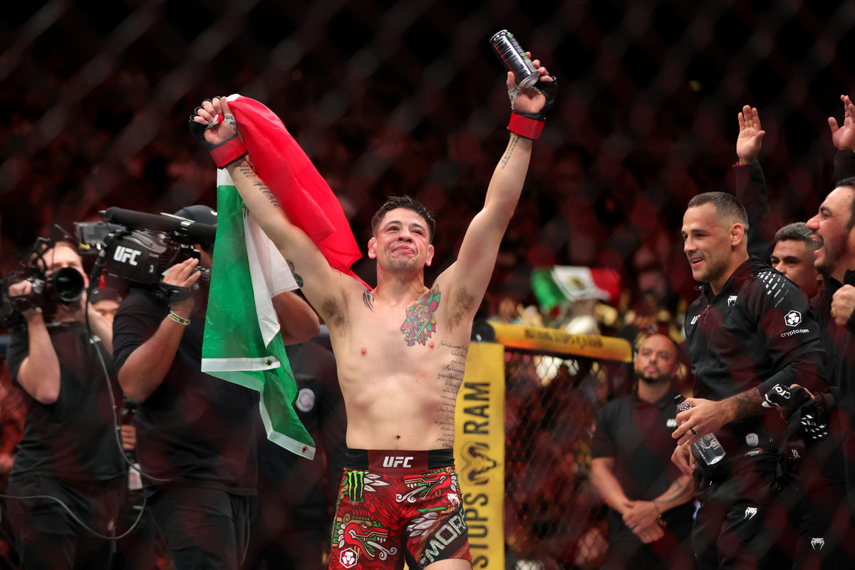 Sep 12, 2026; Glendale, Arizona, UNITED STATES; Brandon Moreno (red gloves) reacts after defeating Joseph Morales (blue gloves) during UFC Fight Night at Desert Diamond Arena. Mandatory Credit: Mark J. Rebilas-Imagn Images