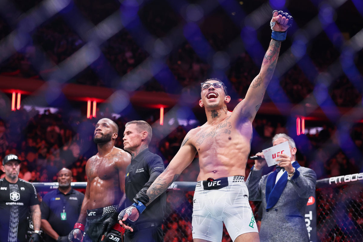 Nov 15, 2025; New York, NY, UNITED STATES; Carlos Prates (blue gloves) reacts after defeating Leon Edwards (red gloves) in the welterweight bout during UFC 322 at Madison Square Garden. Mandatory Credit: Ed Mulholland-Imagn Images