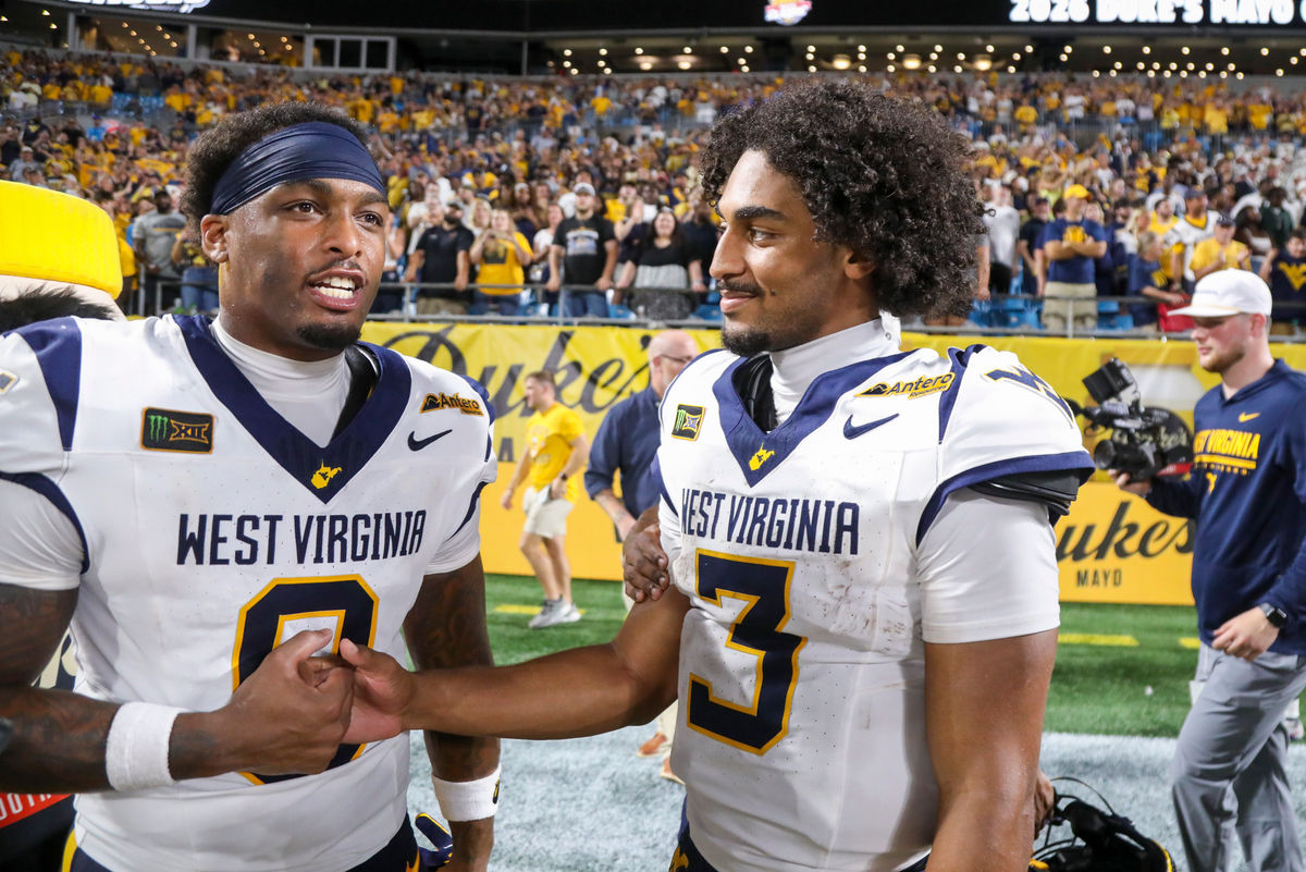 Sep 19, 2026; Charlotte, North Carolina, USA; West Virginia Mountaineers tight end Josh Sapp (0) celebrates with West Virginia Mountaineers quarterback Michael Hawkins Jr. (3) after defeating the Virginia Cavaliers at Bank of America Stadium. Mandatory Credit: Ben Queen-Imagn Images